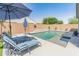 Backyard pool area includes a covered patio and lounge chairs for ultimate relaxation and enjoyment at 24638 N 144Th Ave, Surprise, AZ 85387