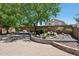Serene backyard boasts mature trees, a water feature, lush landscaping, and a paver patio at 2957 E Melrose St, Gilbert, AZ 85297
