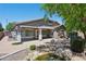 Charming home featuring a covered patio, meticulously designed backyard with lush trees, and a peaceful water feature at 2957 E Melrose St, Gilbert, AZ 85297