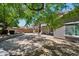 Expansive backyard featuring mature trees, lush landscaping, and a serene water feature at 2957 E Melrose St, Gilbert, AZ 85297