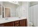 Bathroom with a double sink vanity with wood cabinets and a framed mirror at 2957 E Melrose St, Gilbert, AZ 85297