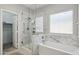 Beautiful bathroom featuring a marble-walled tub and shower with modern fixtures at 2957 E Melrose St, Gilbert, AZ 85297