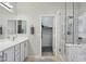 Bright bathroom featuring a marble shower, dual vanities, and walk-in closet at 2957 E Melrose St, Gilbert, AZ 85297