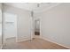 Cozy bedroom featuring neutral carpeting, a ceiling fan, and a doorway to another room at 2957 E Melrose St, Gilbert, AZ 85297