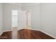 Bedroom with wood floors and an open door leading to a closet and other rooms at 2957 E Melrose St, Gilbert, AZ 85297
