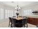 Bright dining area featuring a stylish chandelier, shuttered windows and comfortable seating at 2957 E Melrose St, Gilbert, AZ 85297