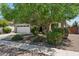 Attractive single-story home with a two-car garage, lush landscaping, and mature trees enhancing its curb appeal at 2957 E Melrose St, Gilbert, AZ 85297