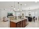 Open kitchen featuring granite countertops, stainless appliances, and stylish pendant lighting at 2957 E Melrose St, Gilbert, AZ 85297