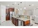 Kitchen featuring stainless steel appliances, dark wood cabinetry, granite countertops and open layout at 2957 E Melrose St, Gilbert, AZ 85297