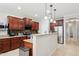 Beautiful kitchen boasts granite countertops, stainless appliances, and ample dark wood cabinetry at 2957 E Melrose St, Gilbert, AZ 85297