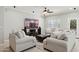 Comfortable living room with neutral furniture, ceiling fan, tile floors and large-screen television at 2957 E Melrose St, Gilbert, AZ 85297