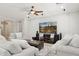 Cozy living room showcasing neutral-toned sofas, a ceiling fan, and a large TV for entertainment at 2957 E Melrose St, Gilbert, AZ 85297