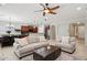 Spacious open-concept living room offering neutral furniture, a ceiling fan, and a view into the kitchen at 2957 E Melrose St, Gilbert, AZ 85297