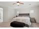 Cozy bedroom featuring a large bed, ceiling fan, soft carpet, and ample natural light at 2957 E Melrose St, Gilbert, AZ 85297