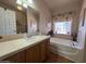 Bathroom with a soaking tub, vanity, and decorative accents at 316 S 74Th Way, Mesa, AZ 85208