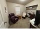 Functional spare bedroom with desk, tv, and comfortable seating at 316 S 74Th Way, Mesa, AZ 85208