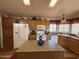 Warm, inviting kitchen featuring an island, lots of counter space, and white appliances at 316 S 74Th Way, Mesa, AZ 85208