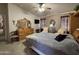 Bright main bedroom featuring a bed with upholstered headboard, dresser and ceiling fan at 316 S 74Th Way, Mesa, AZ 85208