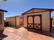 Exterior view of the outbuilding featuring a large barn door and red accents at 316 S 74Th Way, Mesa, AZ 85208