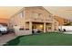 Beautiful backyard featuring putting green, covered patio, and well-maintained landscaping at 33828 N Pate Pl, Cave Creek, AZ 85331