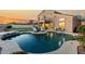 Expansive backyard offering a pool, putting green, lounge seating, and outdoor living space at 33828 N Pate Pl, Cave Creek, AZ 85331
