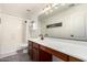 Bathroom featuring a dark wood vanity with white countertop and large mirror at 33828 N Pate Pl, Cave Creek, AZ 85331