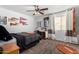Cozy bedroom with sports decor, a ceiling fan, and natural light from a window at 33828 N Pate Pl, Cave Creek, AZ 85331
