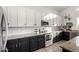 Kitchen features white and black cabinets, stainless steel appliances, and granite countertops at 33828 N Pate Pl, Cave Creek, AZ 85331