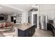 Kitchen with granite countertops, stainless steel appliances, and an island with seating, opening to living areas at 33828 N Pate Pl, Cave Creek, AZ 85331