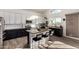 Bright kitchen with white upper cabinets, black lower cabinets, and a large island with seating at 33828 N Pate Pl, Cave Creek, AZ 85331