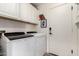 Clean laundry room boasts ample storage, modern appliances, and neutral finishes at 33828 N Pate Pl, Cave Creek, AZ 85331