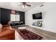 Living room with a leather couch, desk, and ceiling fan at 33828 N Pate Pl, Cave Creek, AZ 85331