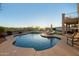 Landscaped backyard featuring a pool, lounge chairs, putting green, and covered patio ideal for outdoor living at 33828 N Pate Pl, Cave Creek, AZ 85331