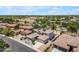 A high angle view of a residential street featuring tile-roofed homes with solar panels, situated in a lush, green neighborhood at 3806 E Taurus Pl, Chandler, AZ 85249
