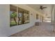Covered back patio with brick pavers, outdoor ceiling fans, and view of backyard landscaping and pool at 3806 E Taurus Pl, Chandler, AZ 85249