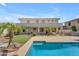 Spacious backyard with pool, lush landscaping, artificial turf, and covered patio for ultimate outdoor enjoyment at 3806 E Taurus Pl, Chandler, AZ 85249