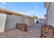 Private backyard with storage shed, metal firewood cages, and drought-tolerant landscaping at 3806 E Taurus Pl, Chandler, AZ 85249