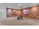 Spacious basement featuring a brick accent wall and table at 3806 E Taurus Pl, Chandler, AZ 85249