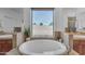 Bathroom featuring soaking tub, tile counters, and nice mirrors at 3806 E Taurus Pl, Chandler, AZ 85249