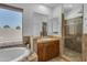Bathroom featuring soaking tub, walk-in shower and large window at 3806 E Taurus Pl, Chandler, AZ 85249