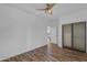 This bedroom boasts stylish floors, ceiling fan, and a closet with mirrored sliding doors at 3806 E Taurus Pl, Chandler, AZ 85249