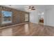 Bedroom with two large windows, brick accent wall and wood floors at 3806 E Taurus Pl, Chandler, AZ 85249