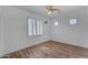 Bedroom featuring wood-look floors, ceiling fan and shuttered windows at 3806 E Taurus Pl, Chandler, AZ 85249