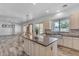 Open-concept design with kitchen island, stainless steel appliances, and seamless flow into the living area at 3806 E Taurus Pl, Chandler, AZ 85249