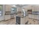 Modern kitchen with stainless steel appliances, center island, and stylish backsplash at 3806 E Taurus Pl, Chandler, AZ 85249