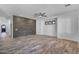 Spacious living room showcases a striking accent wall, wood-look tile flooring, and recessed lighting at 3806 E Taurus Pl, Chandler, AZ 85249