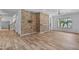 A spacious living room boasts wood-look flooring and a brick feature wall with natural light at 3806 E Taurus Pl, Chandler, AZ 85249