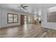Open floor plan featuring wood-look tile floors, connecting the living area, kitchen, and backyard access at 3806 E Taurus Pl, Chandler, AZ 85249