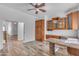 Bright office with custom cabinets and a unique island design with wood-look tile flooring at 3806 E Taurus Pl, Chandler, AZ 85249