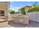 Outdoor kitchen features a stainless steel grill, stone accents, and space for entertaining at 3806 E Taurus Pl, Chandler, AZ 85249